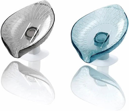 Grey silicone self-draining soap dish mounted on white bathroom tiles holding a dry bar of soap